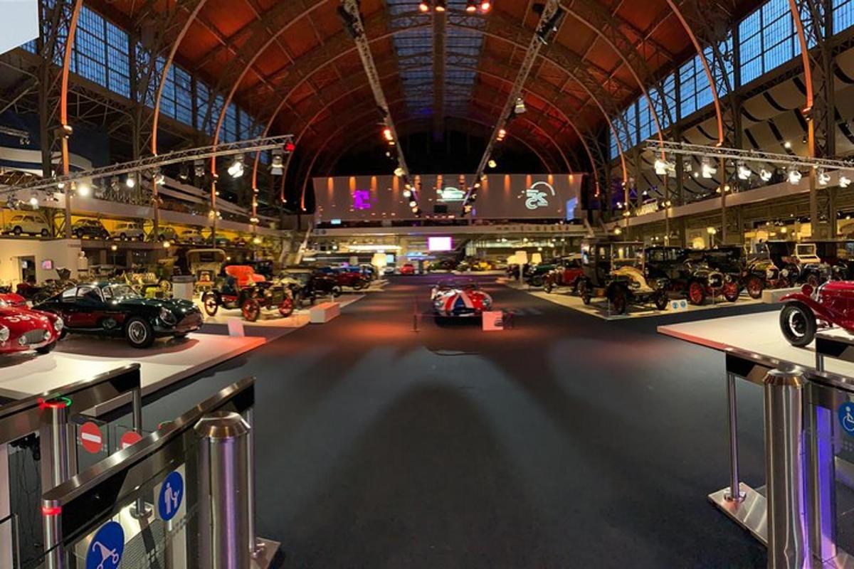 a large room filled with lots of cars on display