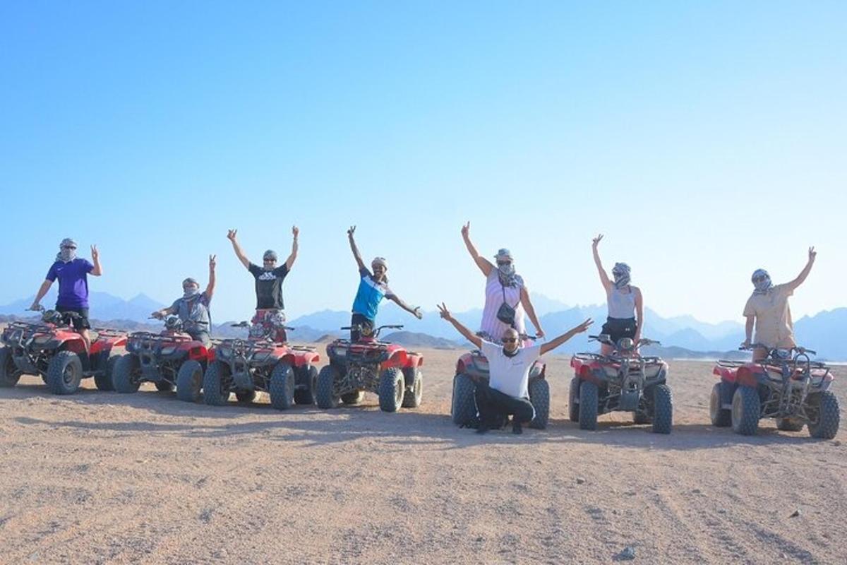 isang grupo ng mga tao sa atvs sa disyerto