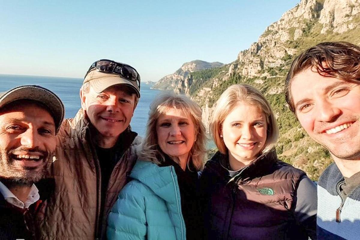 a group of people standing in front of a mountain