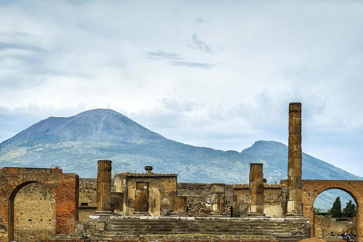 an ancient building with a mountain in the background