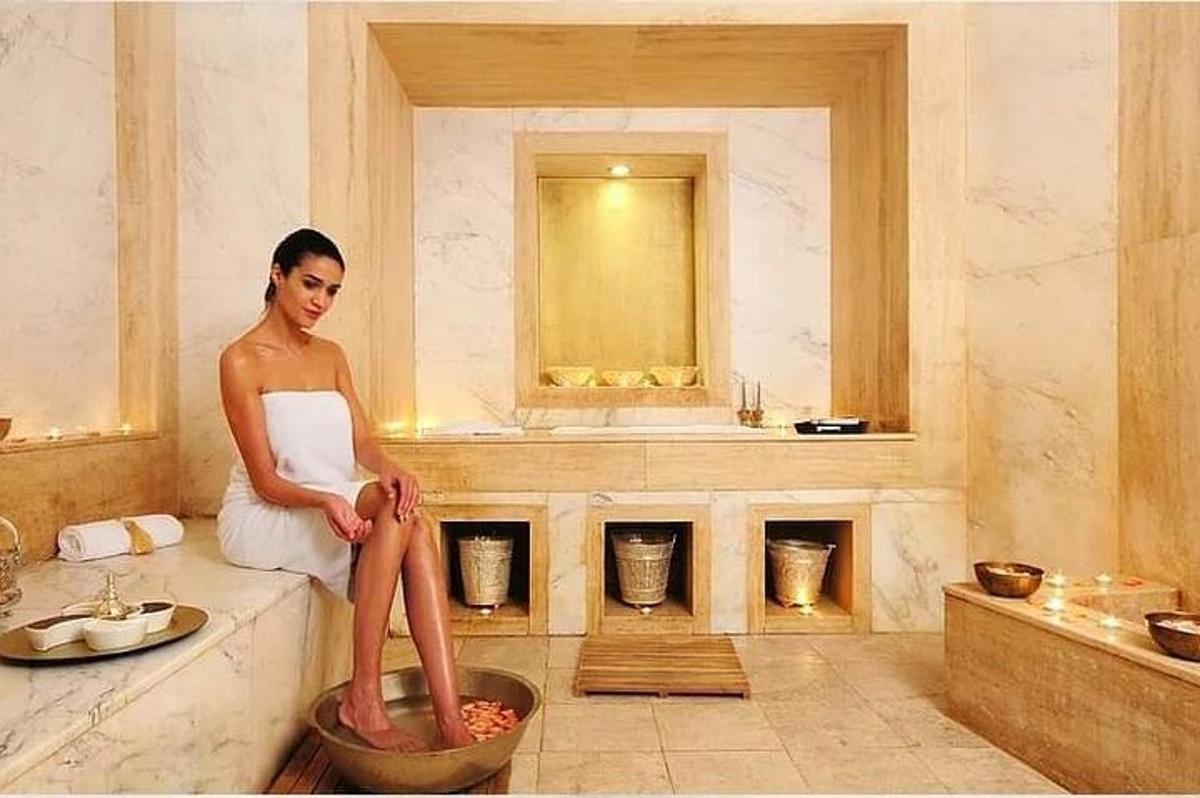 a woman sitting on a tub in a bathroom