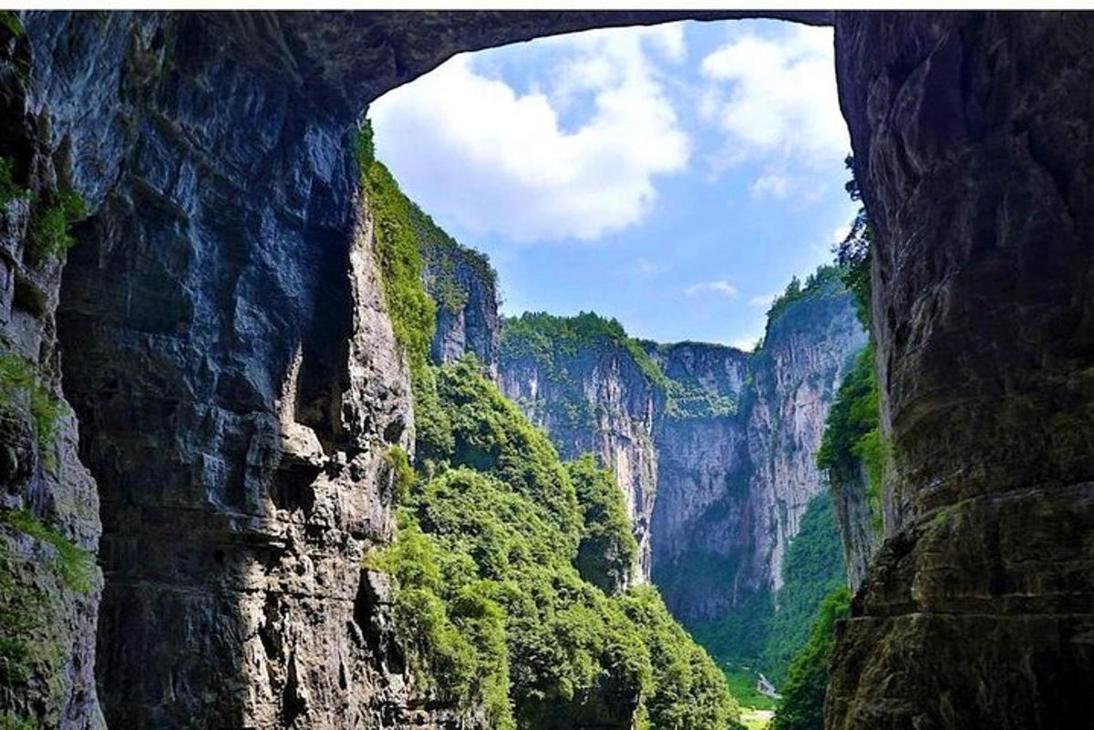 a view of a canyon from a cave in a mountain