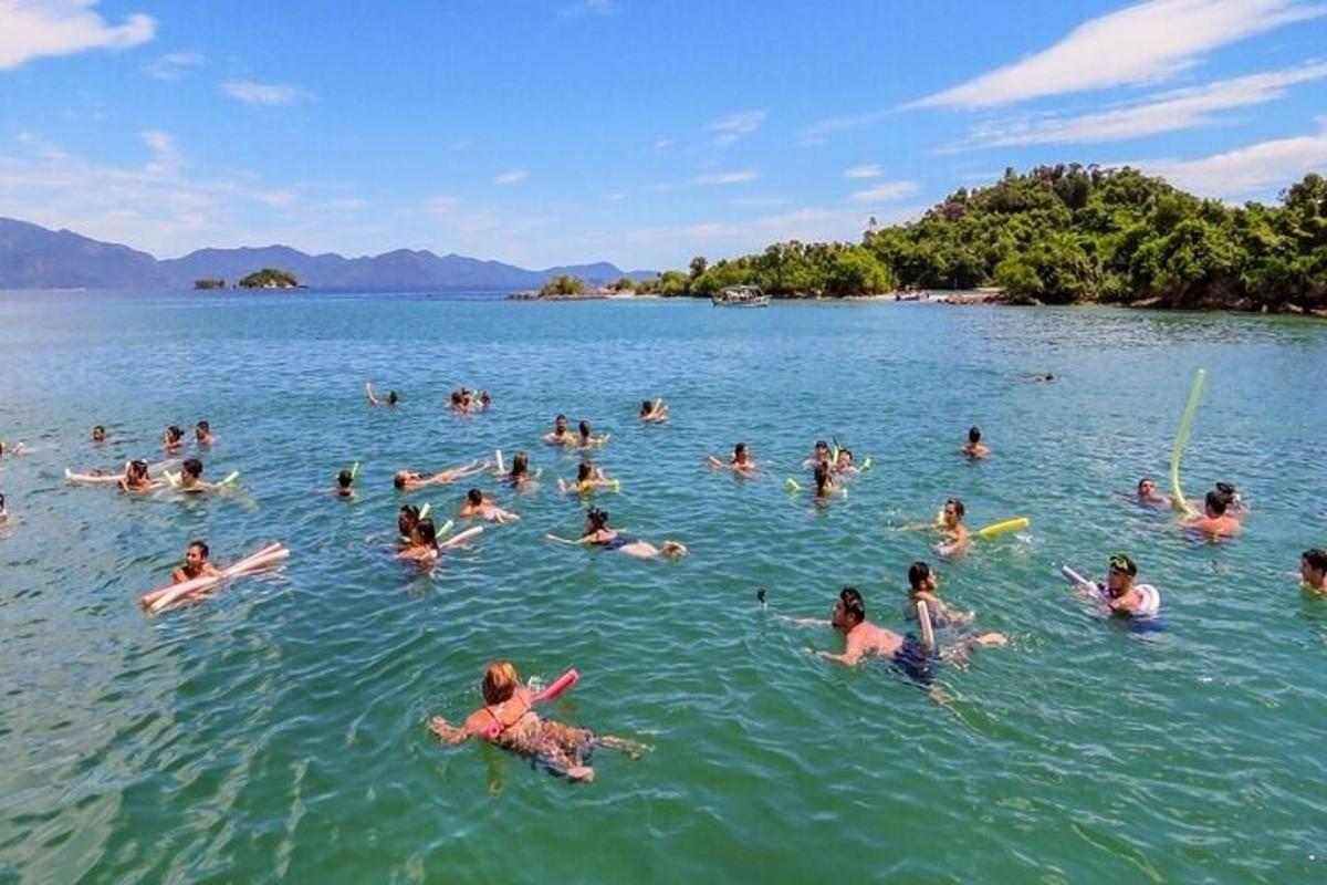 a large group of people swimming in the water