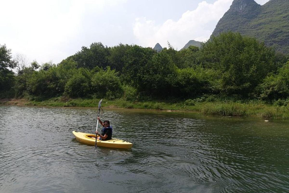 a person in a yellow kayak on a river