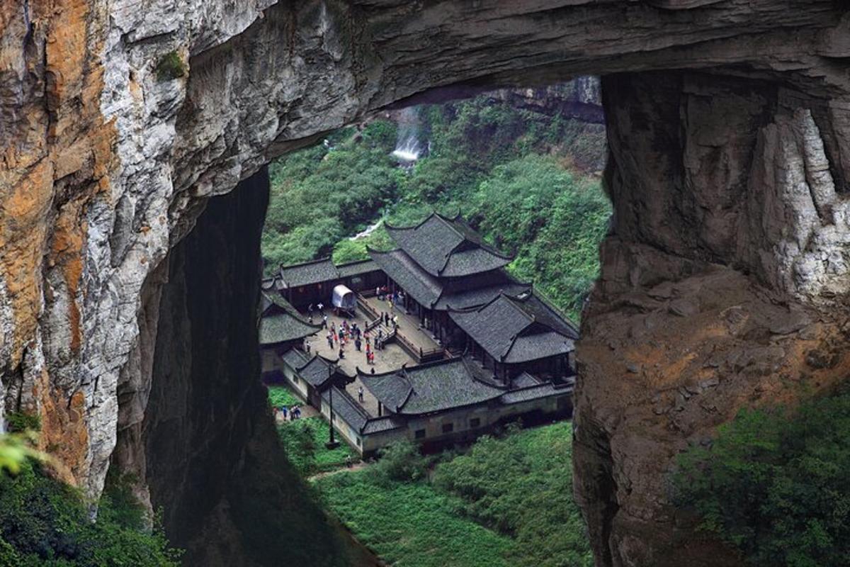 a view of a building on a mountain through a cave
