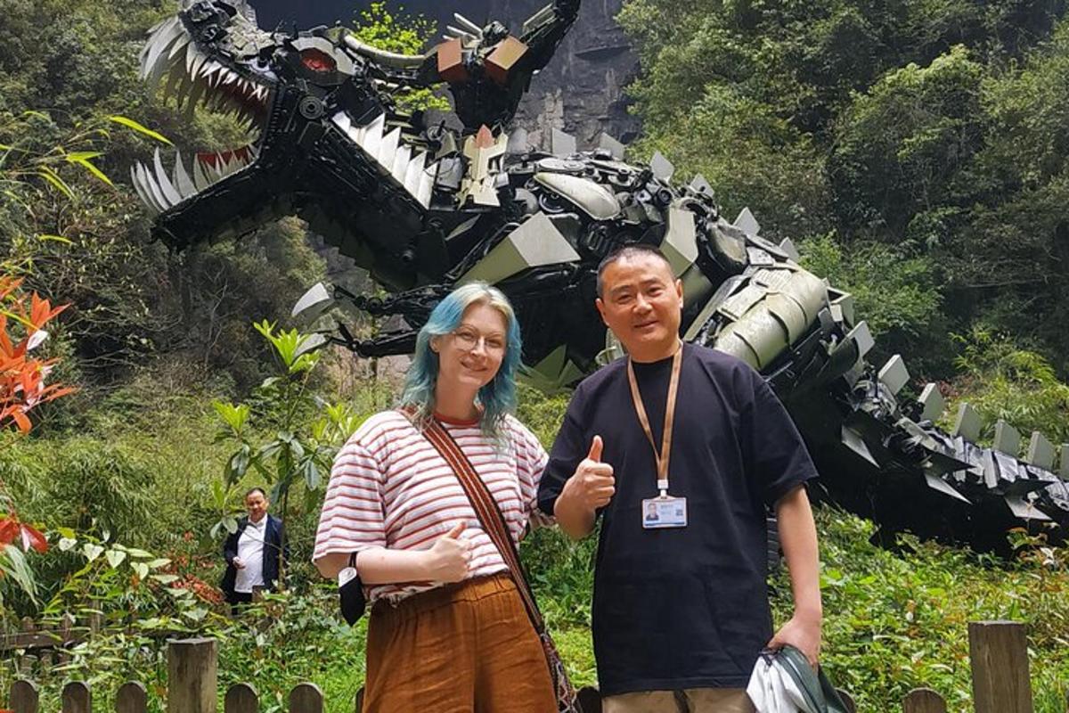a man and a woman standing in front of a robot