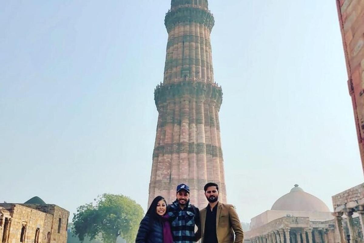a group of people standing in front of a tower