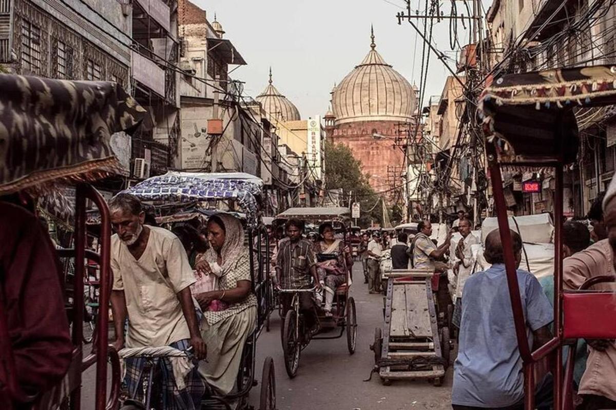 a group of people riding rickshaws on a busy city street