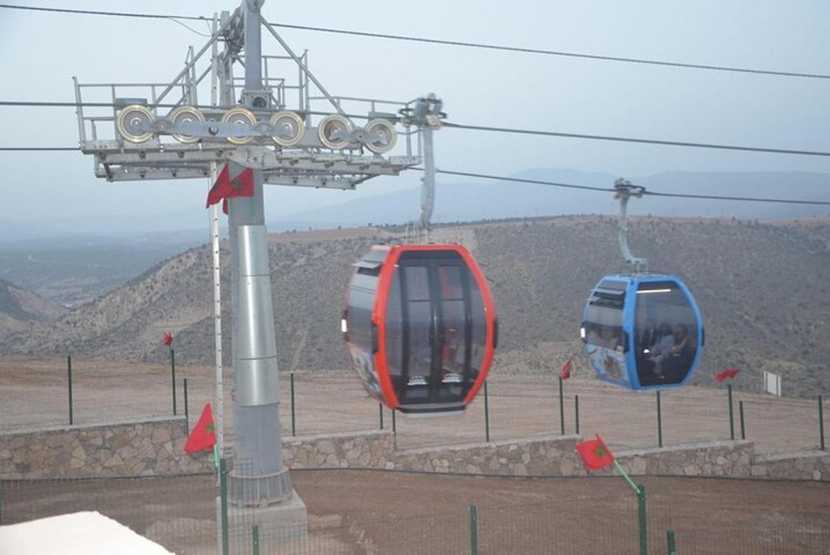 two blue and red cable cars on a mountain