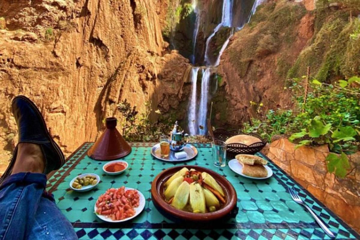 a table with food on it next to a waterfall