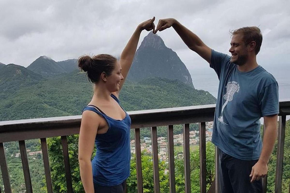 a man and a woman standing on a balcony with a mountain