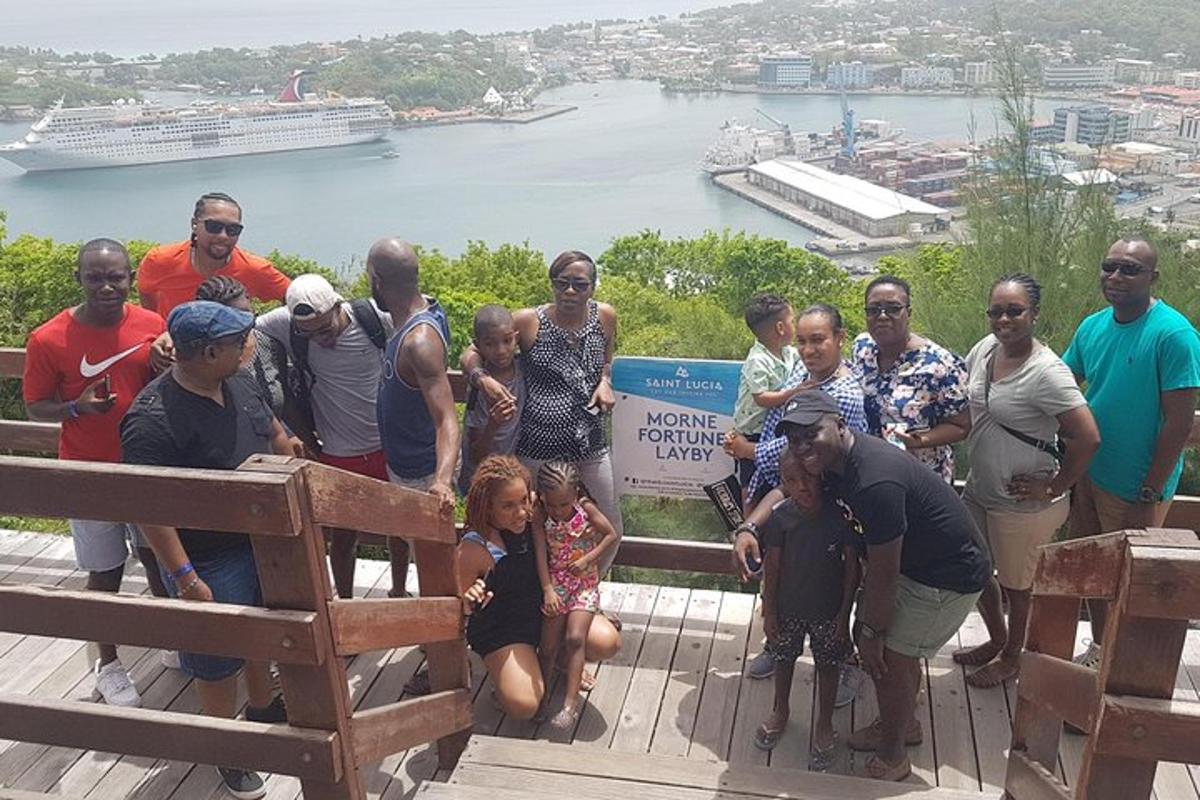 a group of people posing for a picture in front of the water