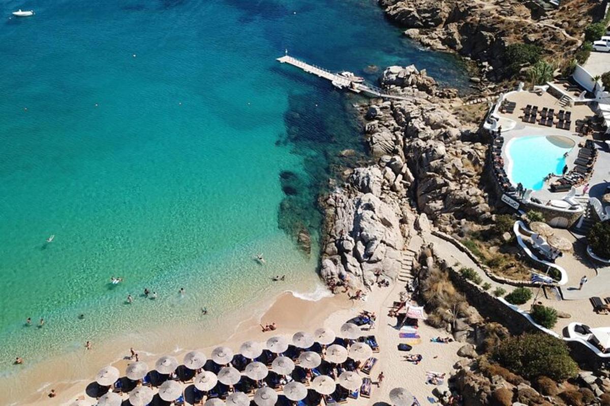an aerial view of a beach with people and umbrellas