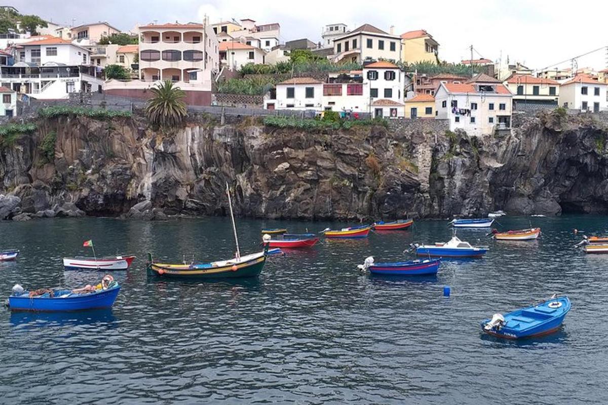 a group of boats in a body of water with buildings
