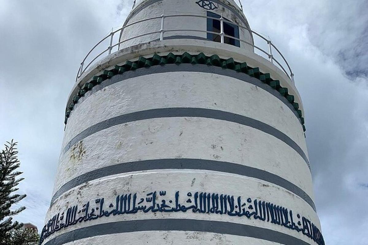 a lighthouse with a sign on the side of it