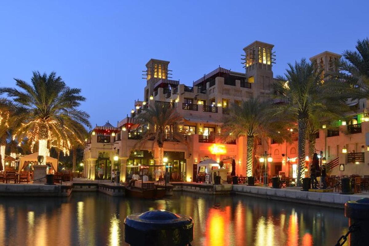 a river with buildings and palm trees at night
