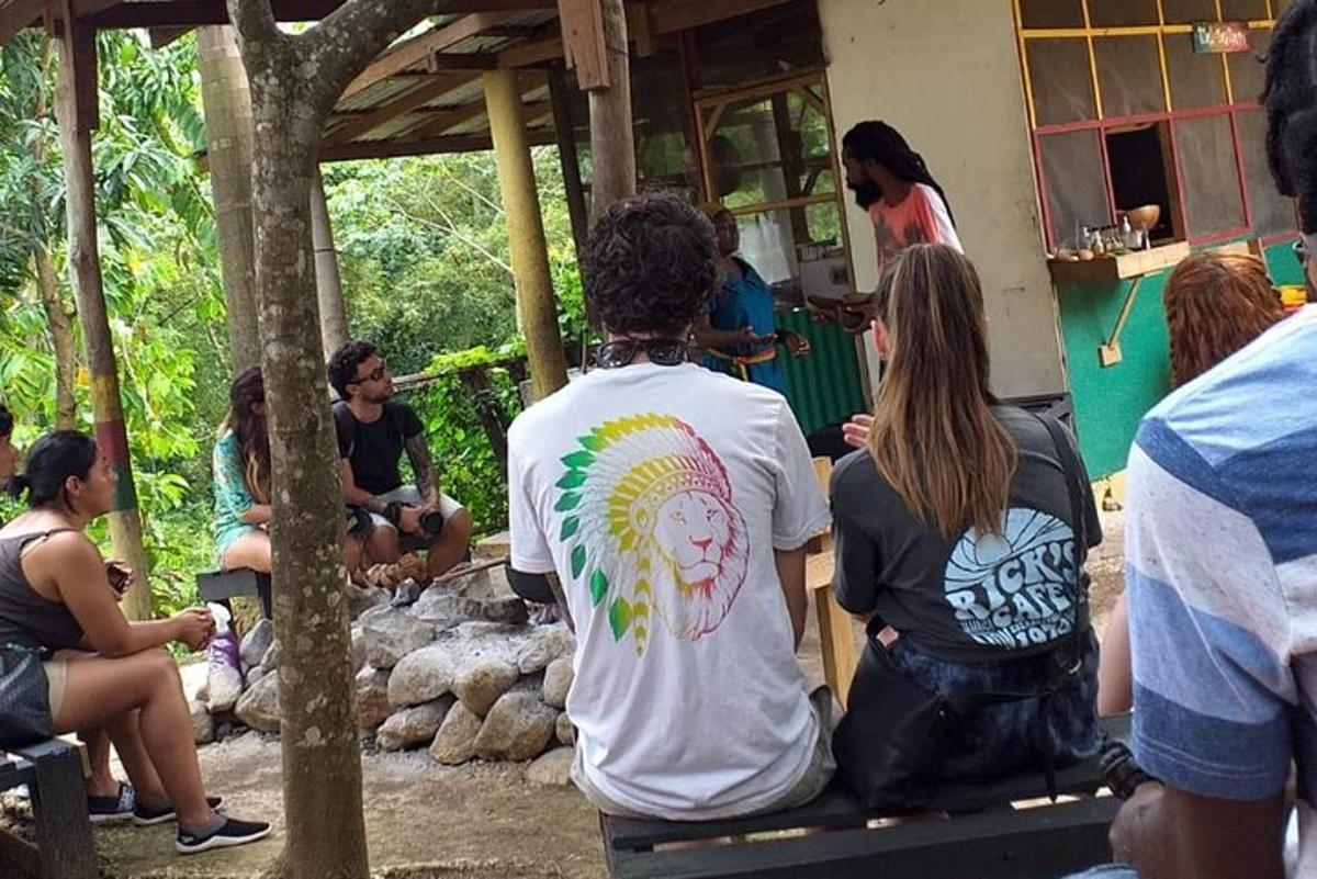 a group of people sitting outside of a house