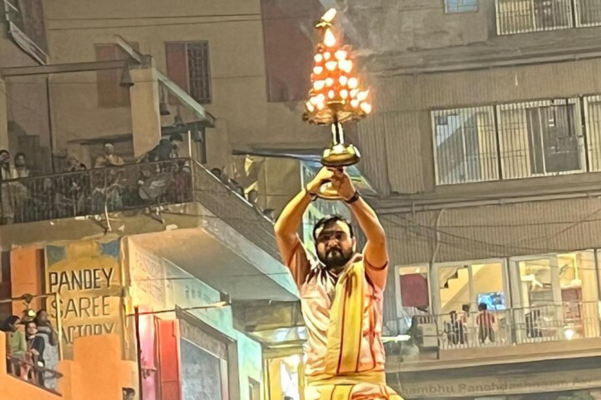 a man holding up a light on a street