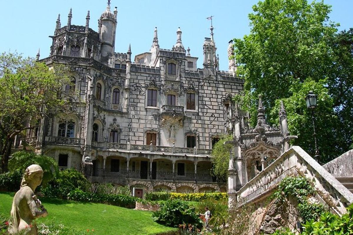 an old castle with a statue in front of it