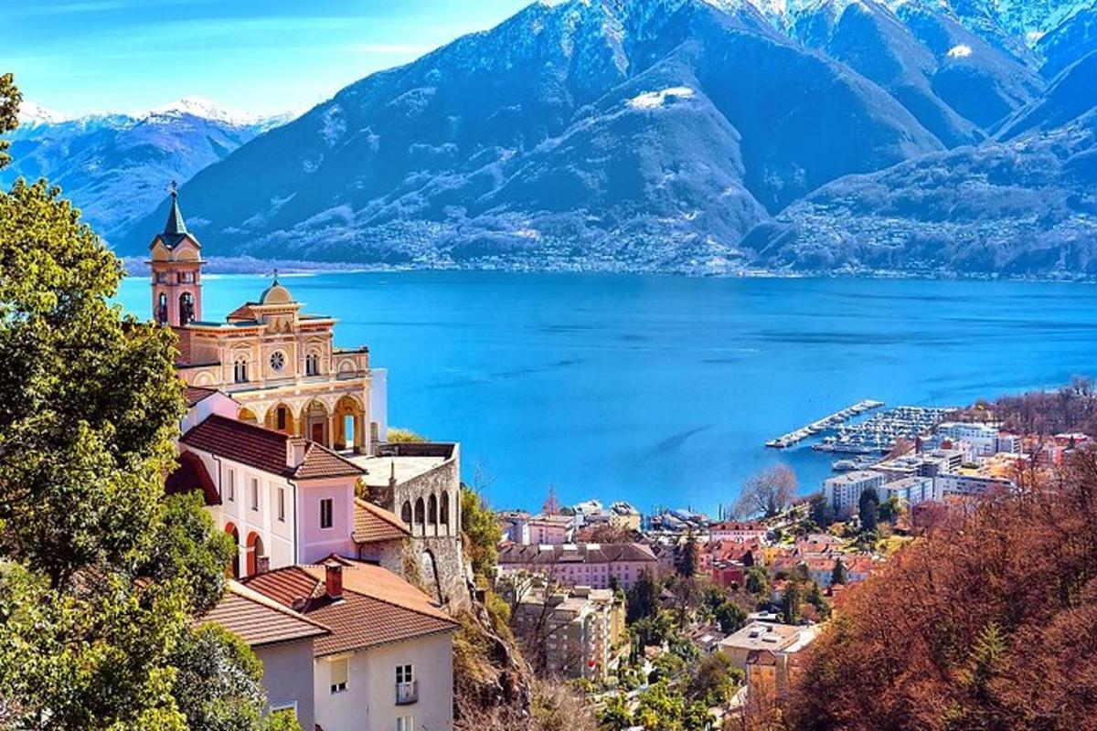 Blick auf eine Stadt mit See und Bergen