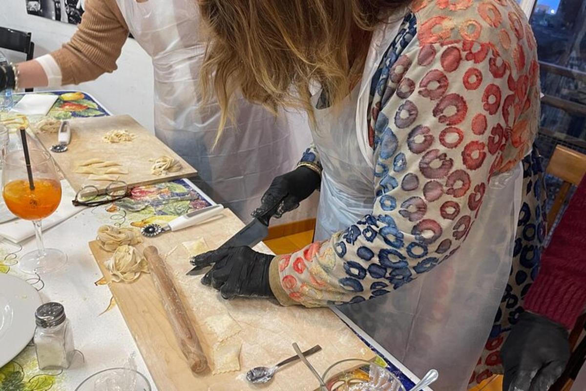 a woman in a kitchen preparing food on a cutting board