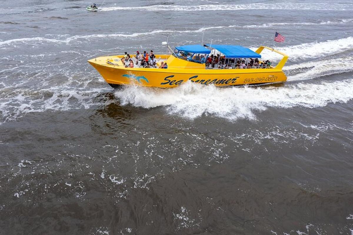 a yellow boat with a bunch of people on it in the water