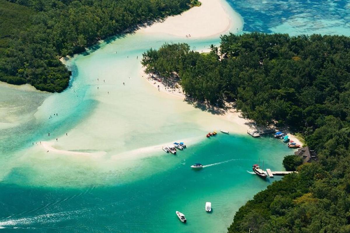 an aerial view of a beach with boats in the water