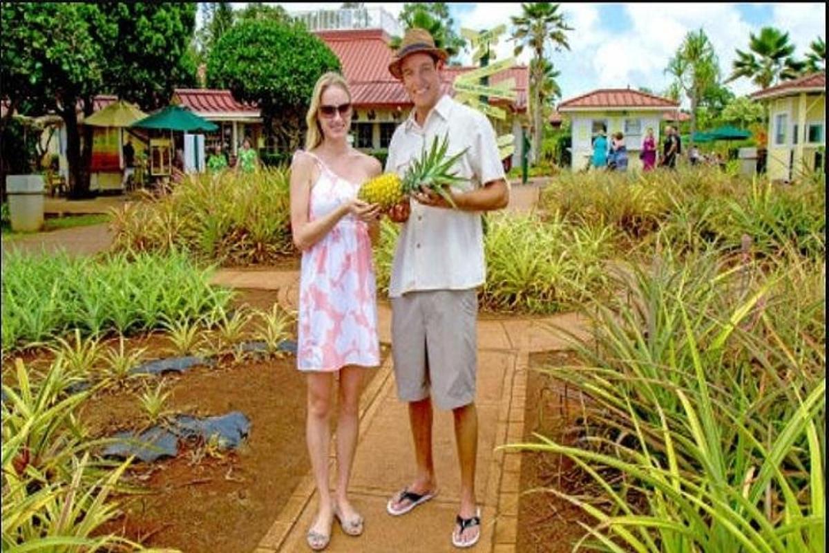 um homem e uma mulher segurando um buquê de plantas