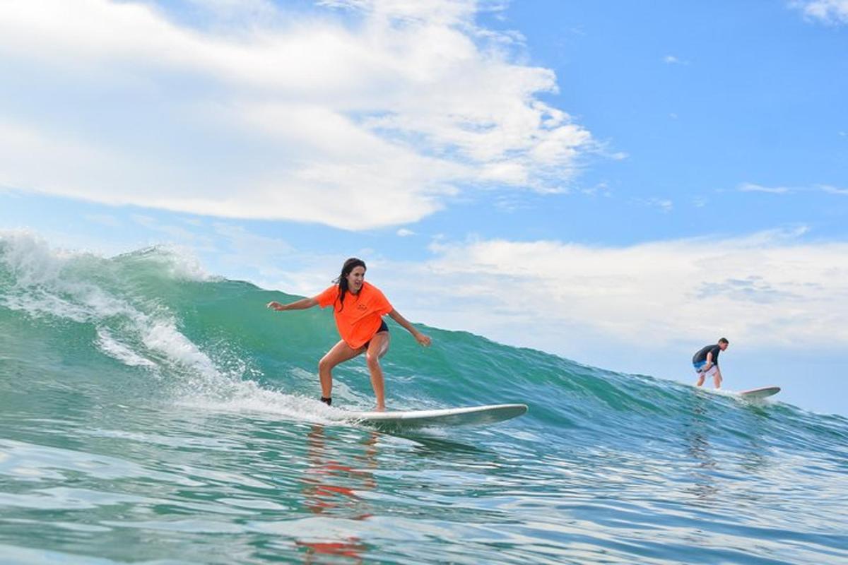 a woman riding a wave on a surfboard in the ocean