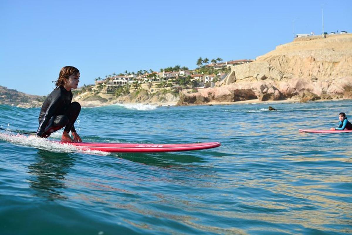 a young girl riding a surfboard in the ocean