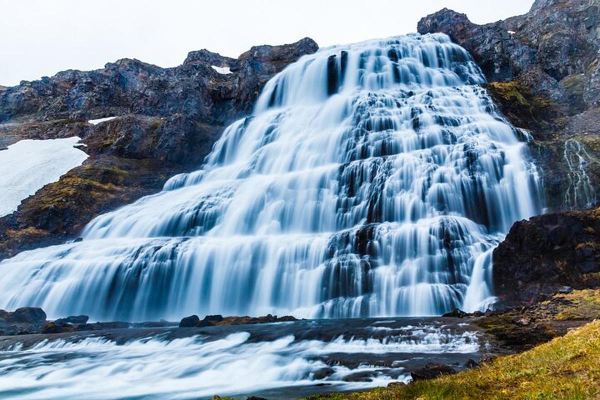 a waterfall on the side of a mountain