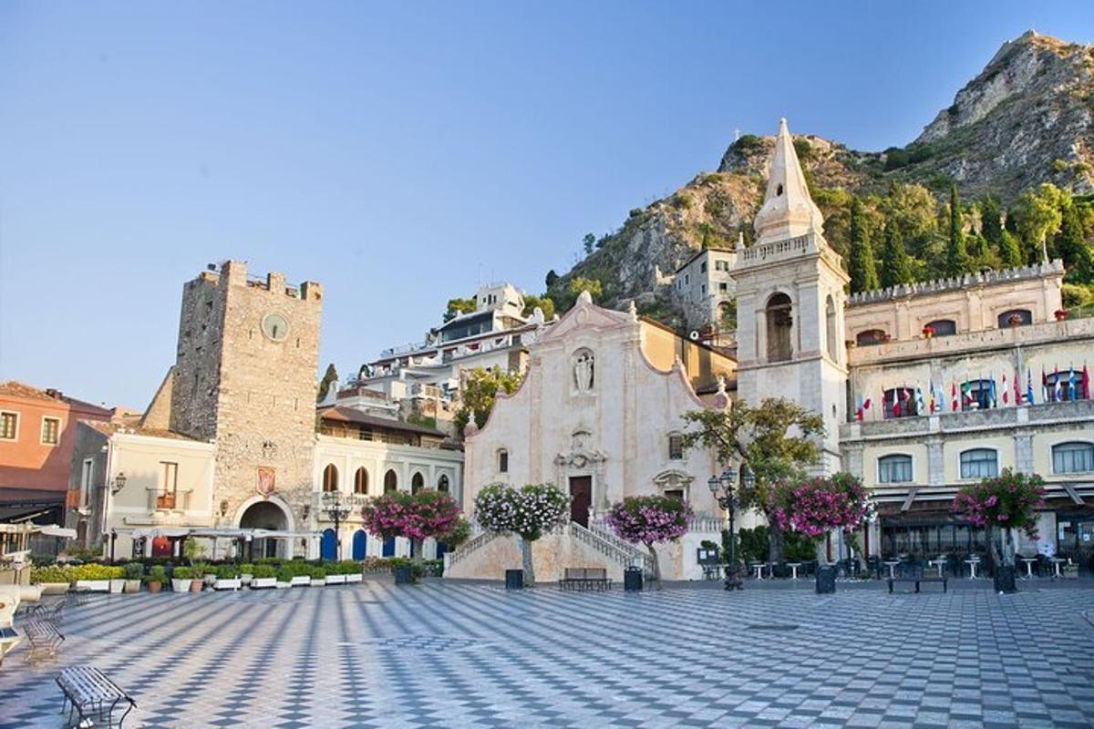 a large building with a mountain in the background