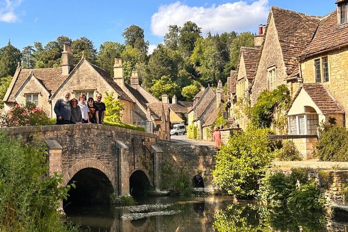a group of people standing on a bridge over a river