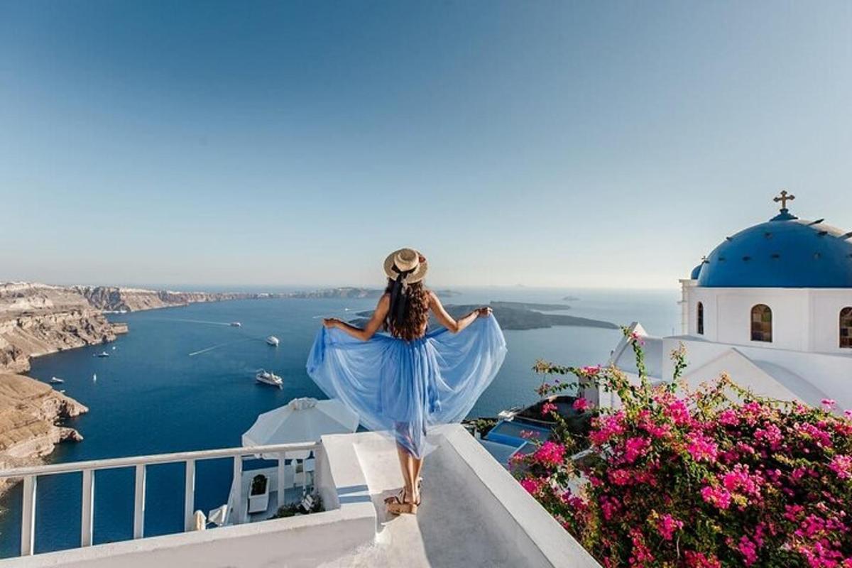 a woman in a blue dress walking down a stairs looking out at the ocean