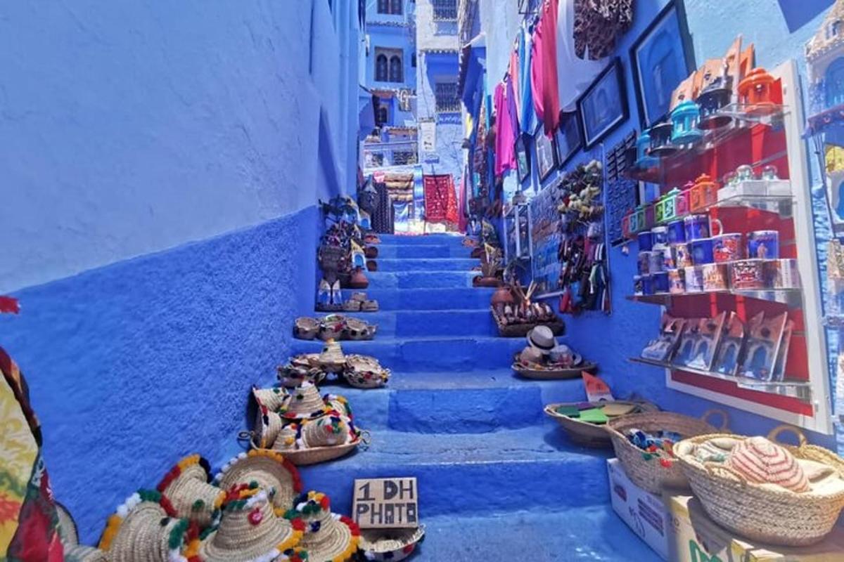 a group of people sitting on the stairs in a blue alley
