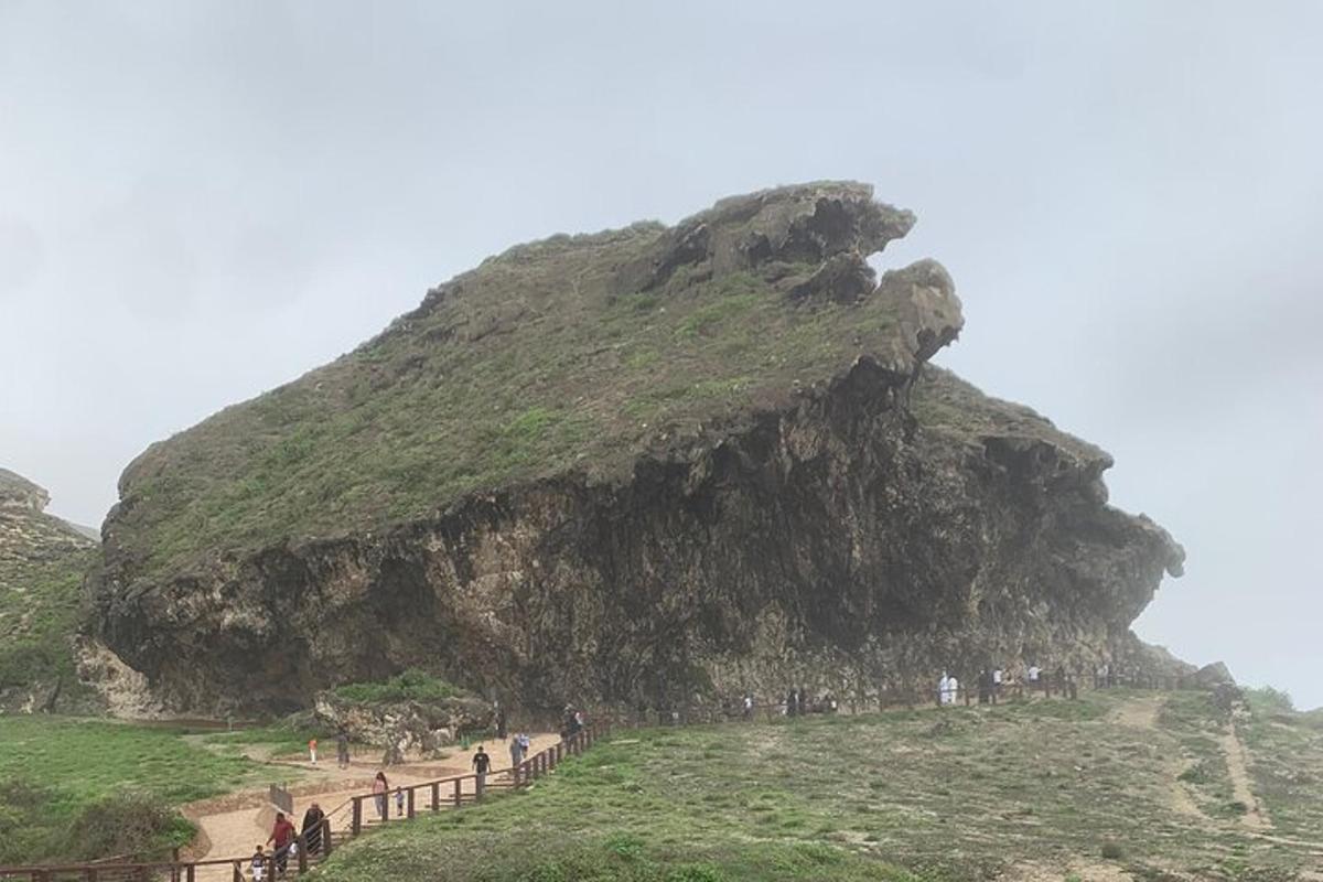 a group of people walking up a mountain