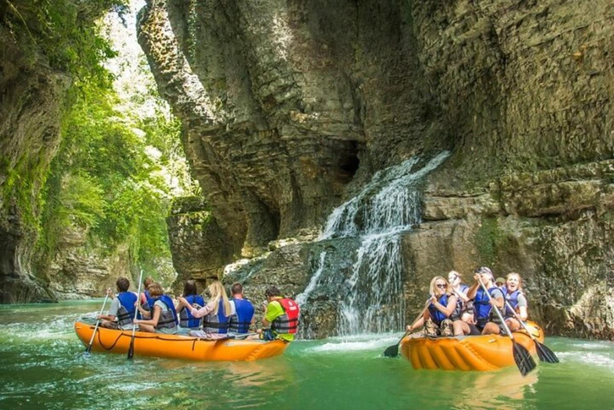 a group of people on rafts in a waterfall