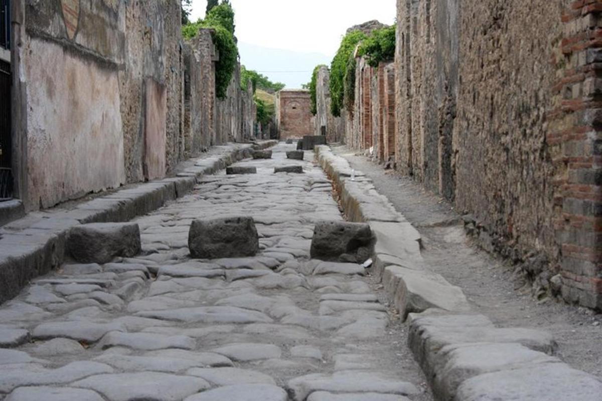 an alley with rocks on a stone street