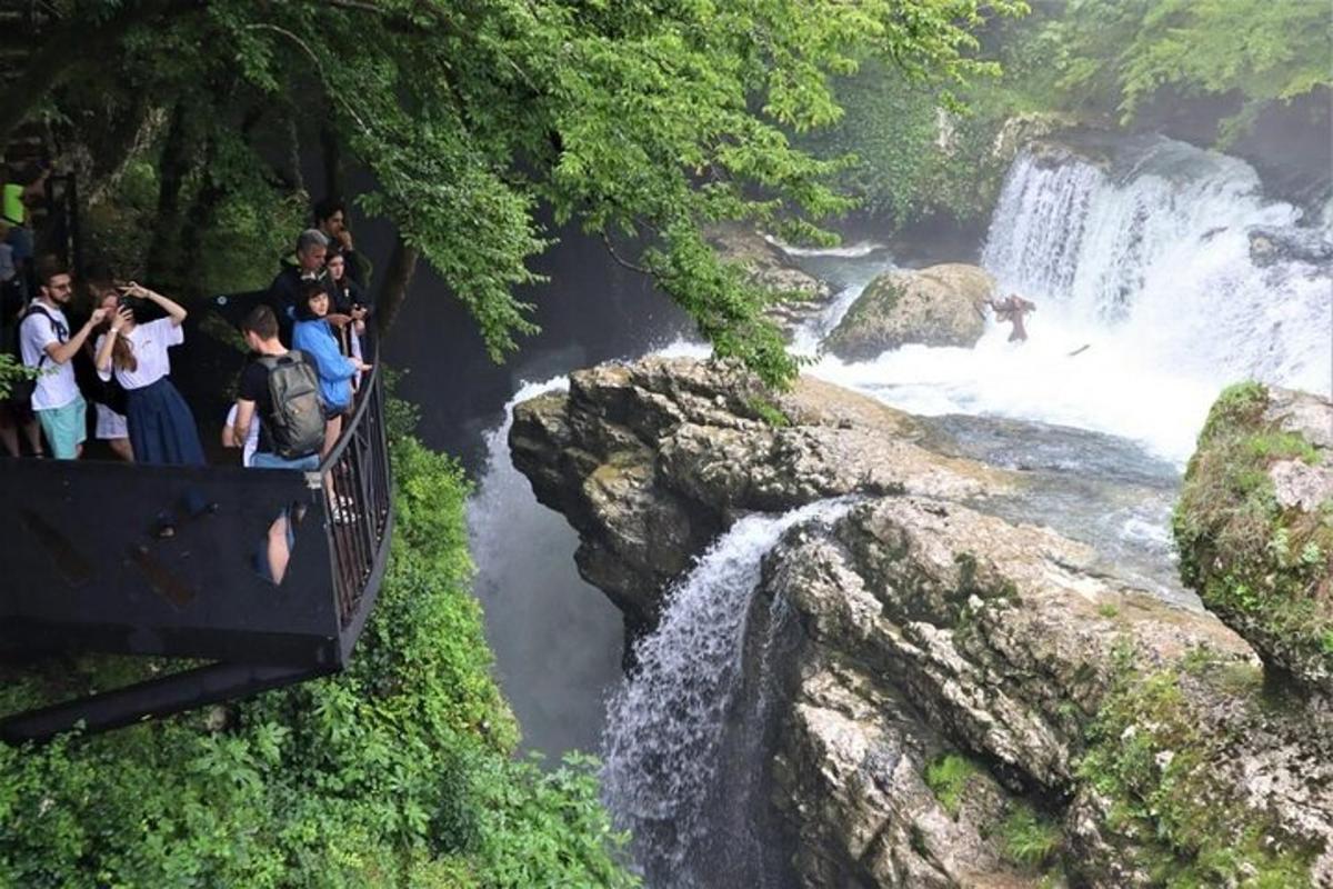 a group of people riding on a boat in a waterfall
