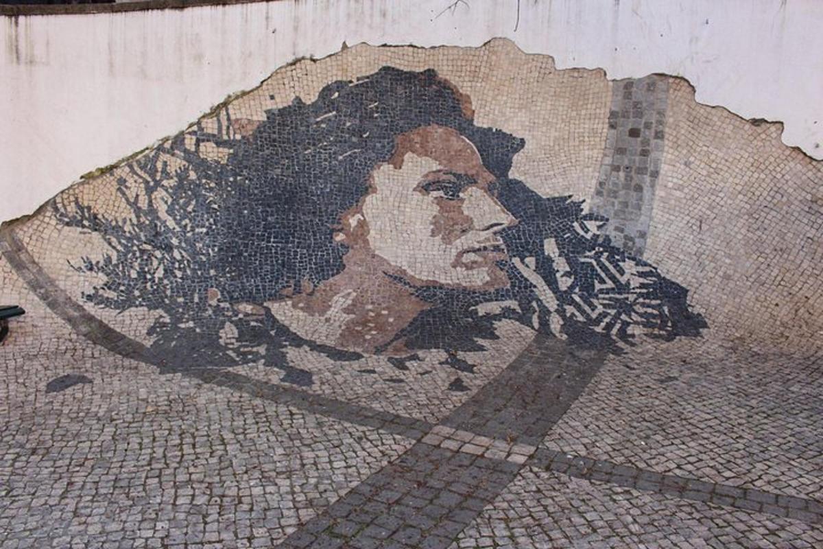a mosaic of a woman on the side of a wall