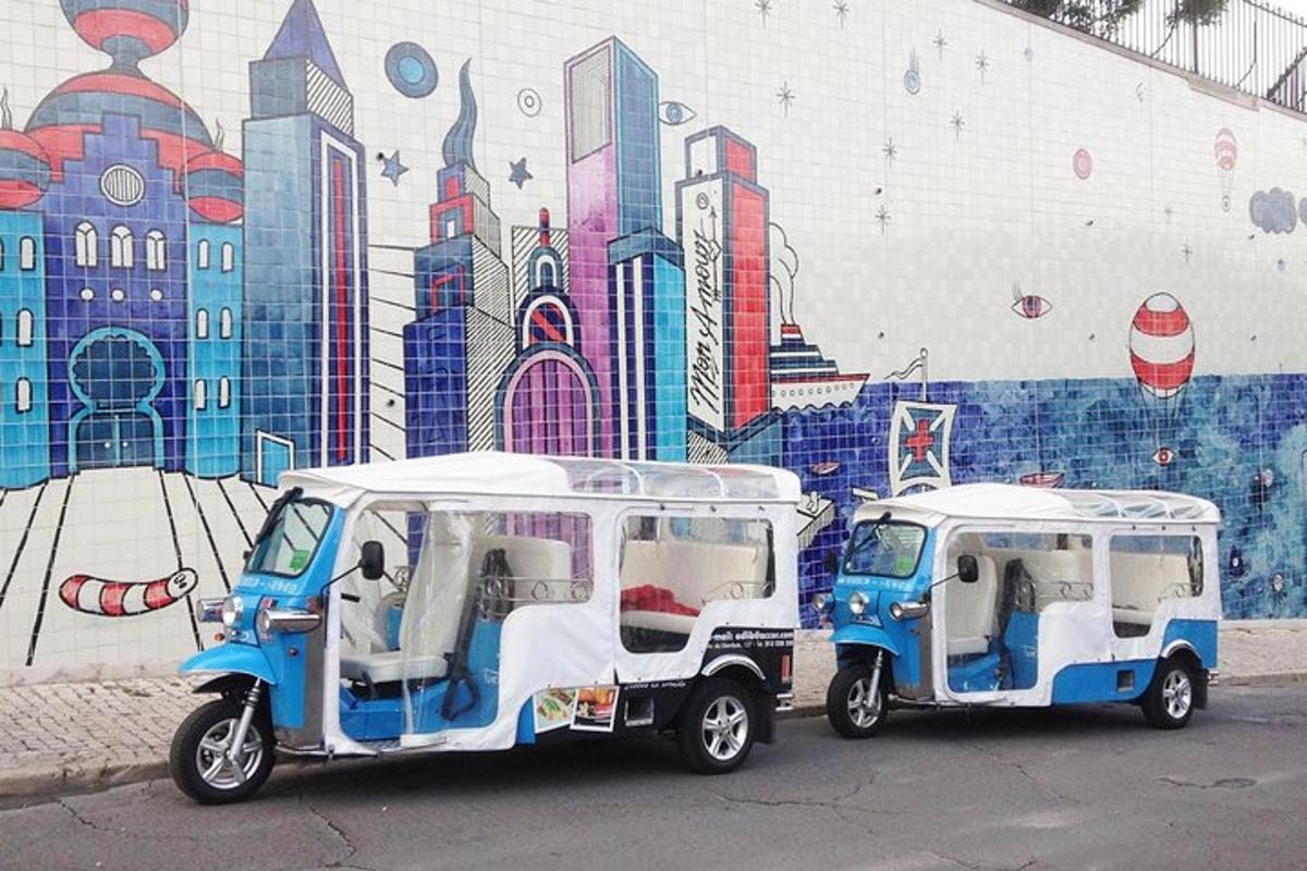 two golf carts parked in front of a mural