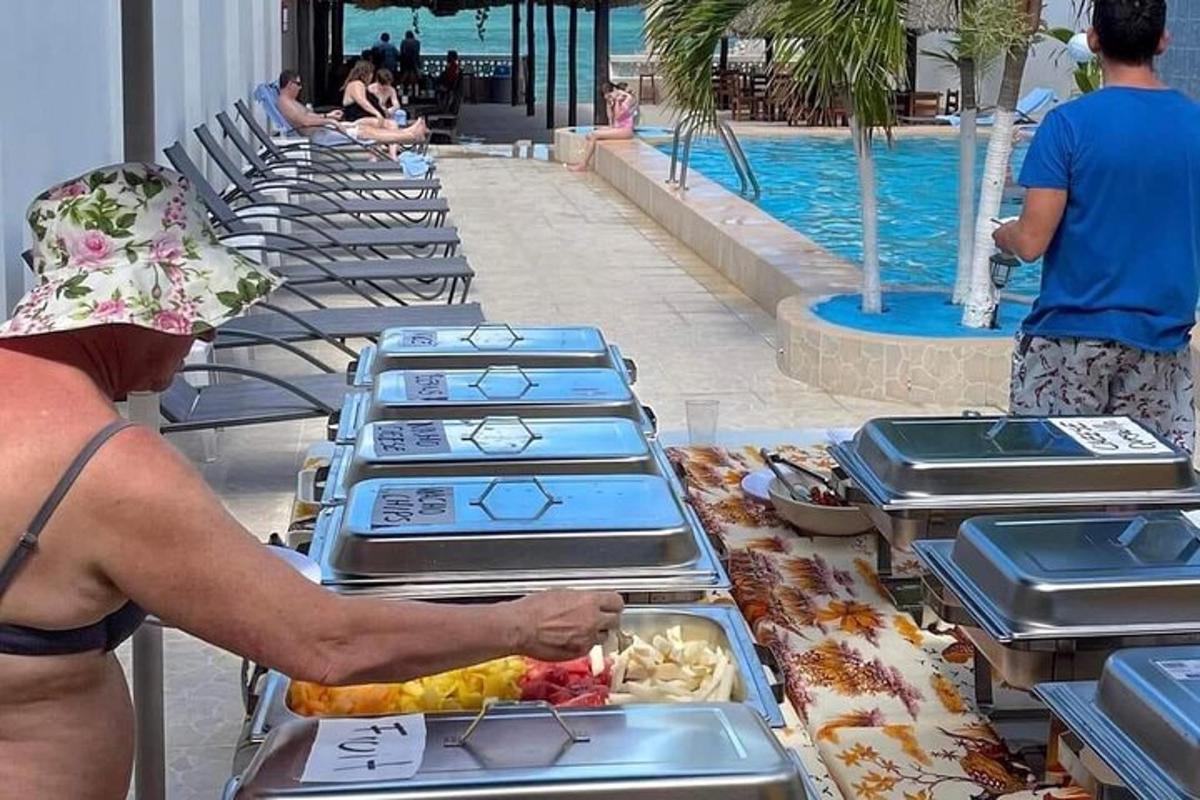 a man preparing food at a buffet at a resort