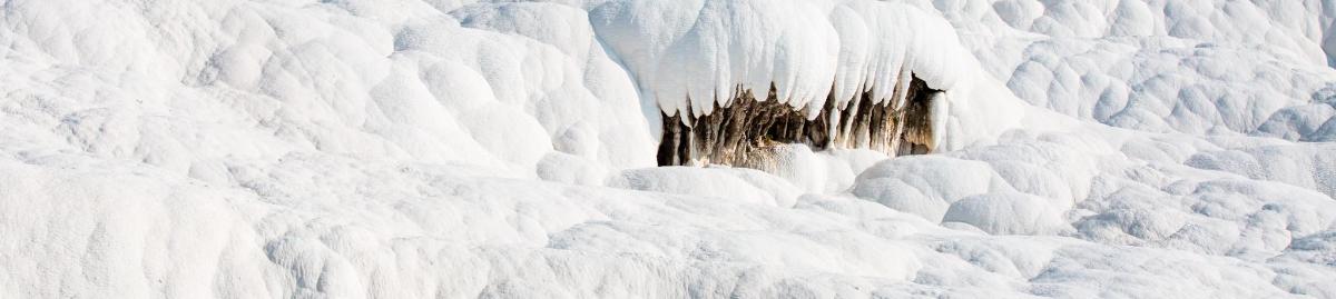 an ice wall with snow on it