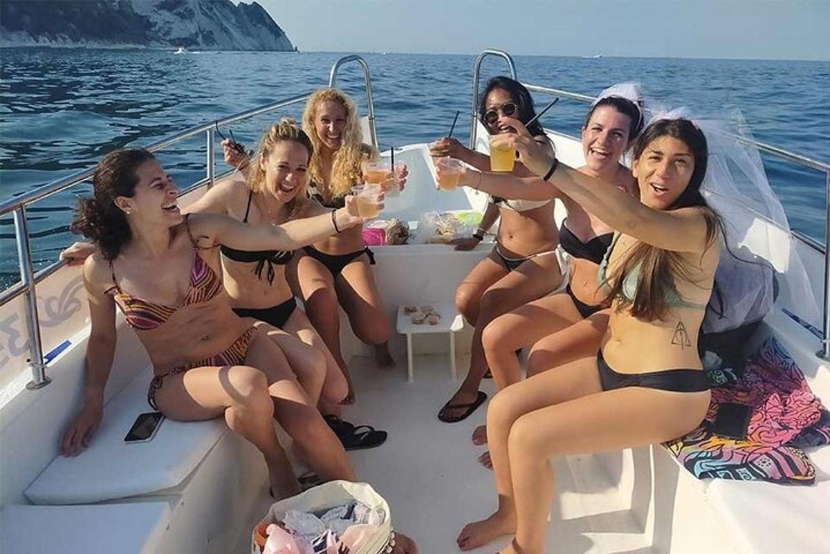 a group of women in bathing suits on a boat