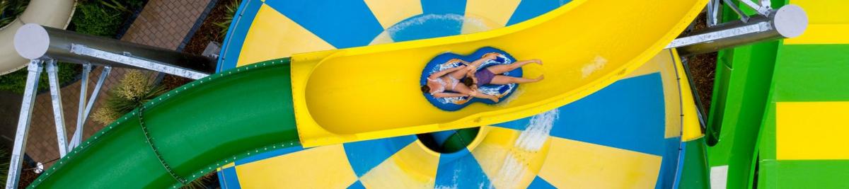 a close up of a colorful slide at a playground