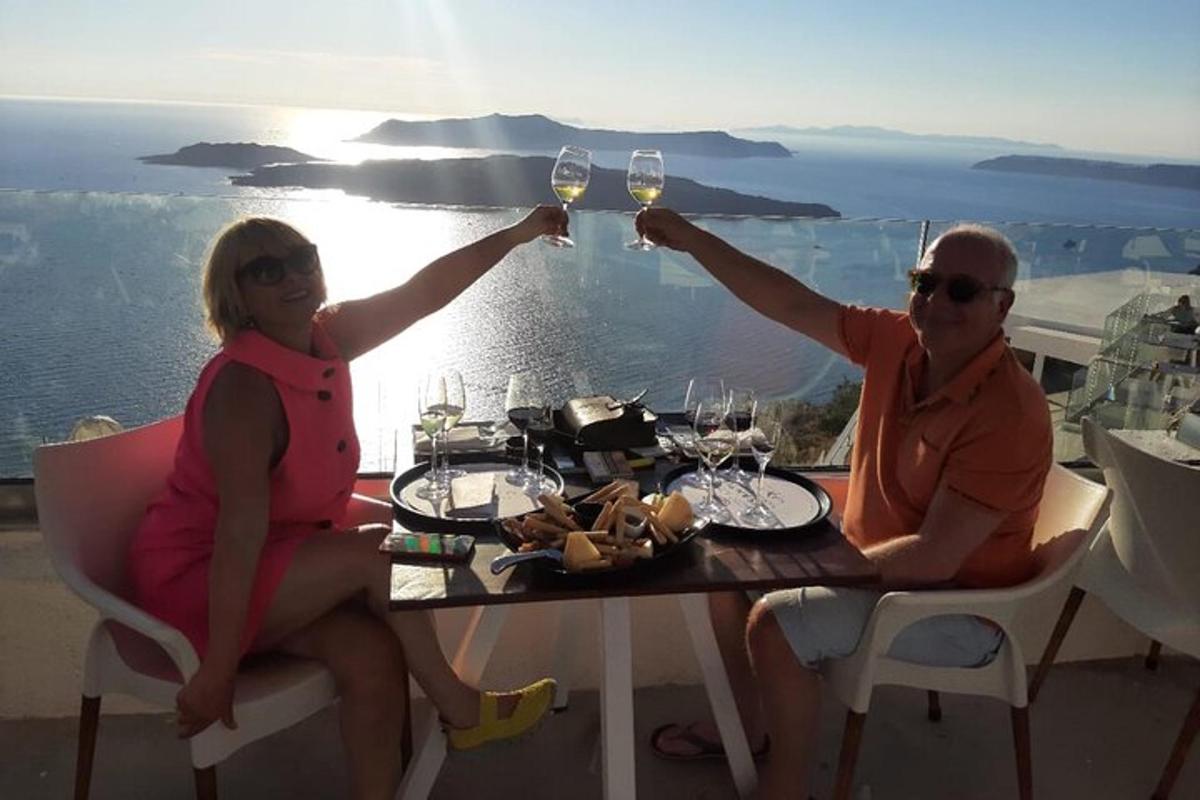 un uomo e una donna seduti a un tavolo con bicchieri di vino