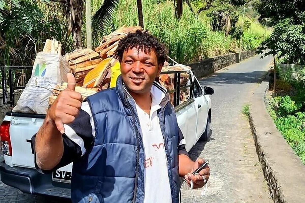 a man giving a thumbs up while standing next to a car