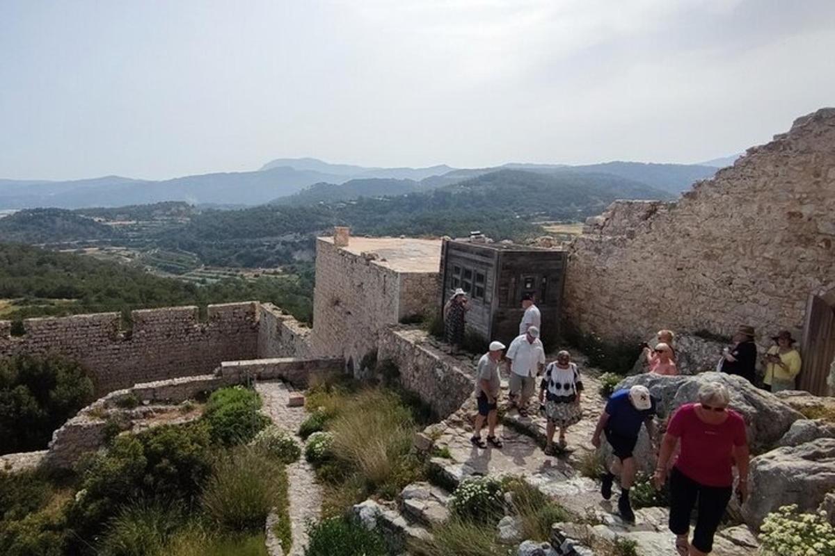 a group of people walking up a stone building