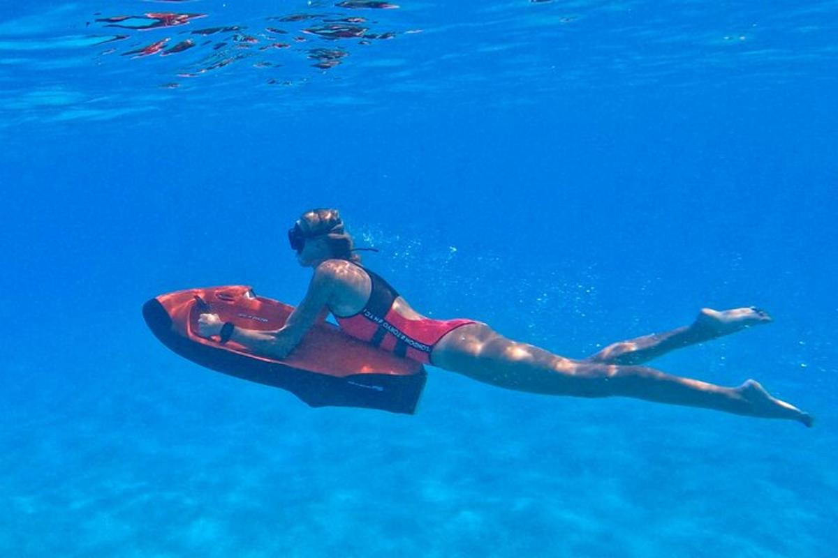 a woman floating on a surfboard in the water