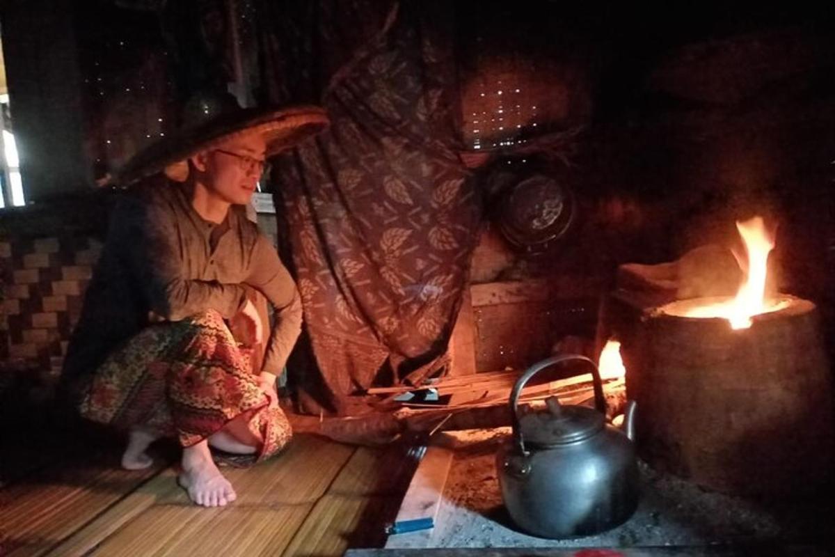 a woman sitting on the floor next to a fire